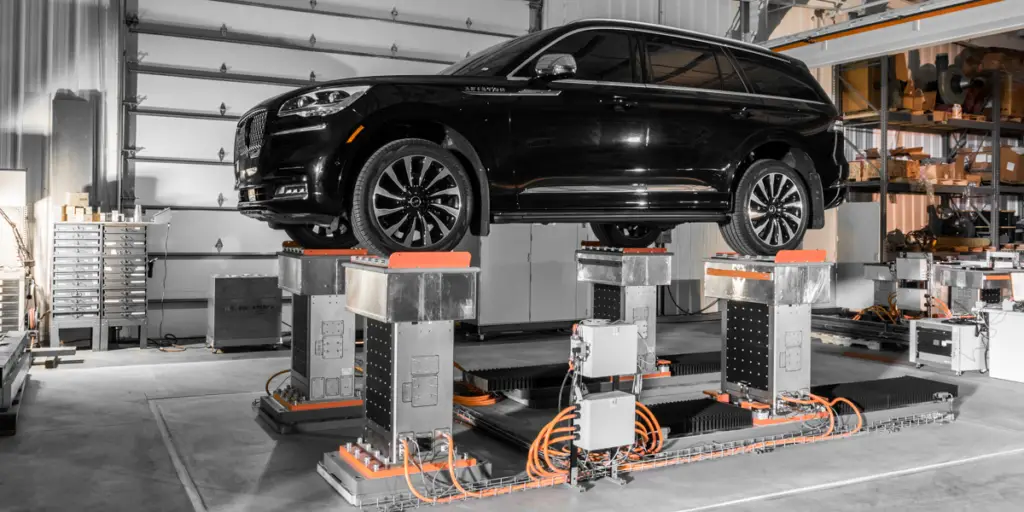 Black suv on four poster testing system